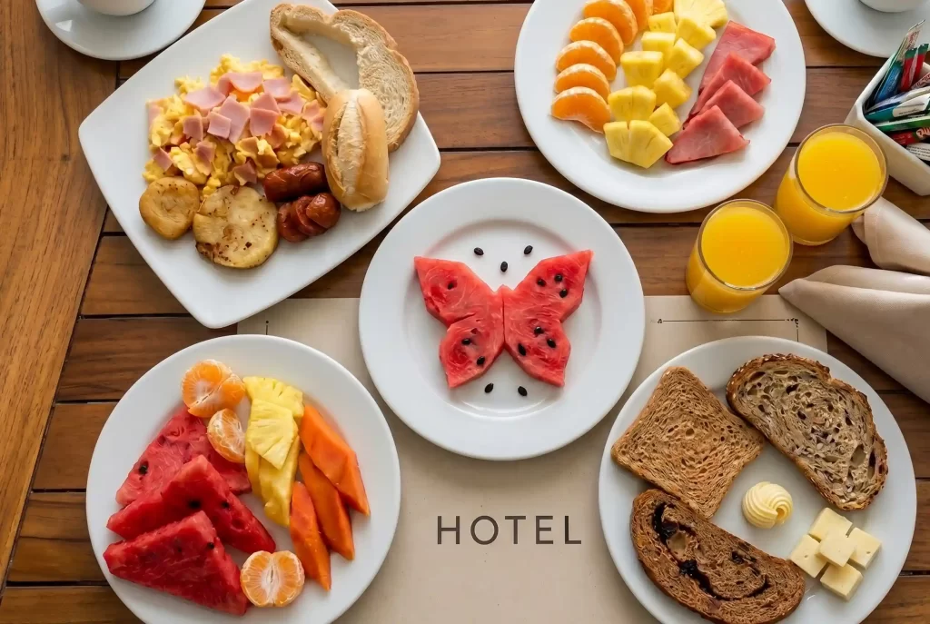 Hotel Regatta Cartagena morning breakfast with fresh tropical fruits, eggs, bread and orange juice.