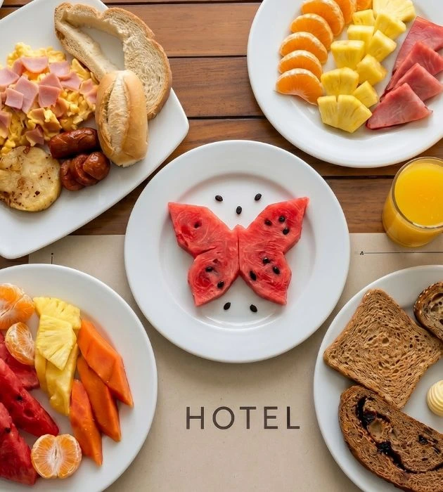 Hotel Regatta Cartagena morning breakfast with fresh tropical fruits, eggs, bread and orange juice.