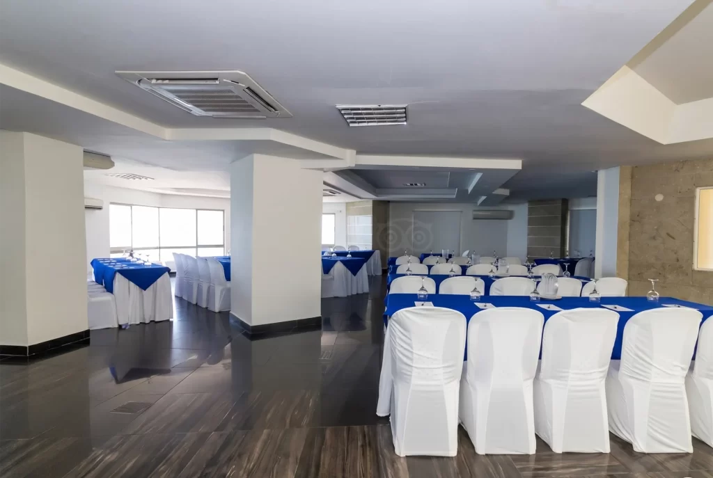 Corporate event room at Hotel Regatta Cartagena set up in classroom style with blue tables and white chairs