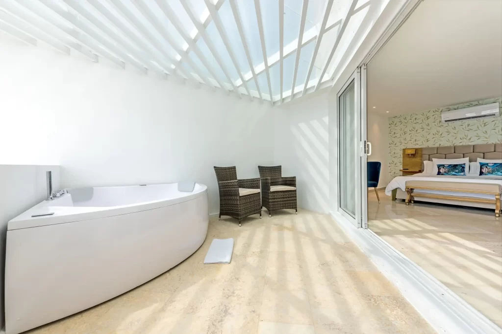 Suite with private jacuzzi on semi-open terrace and king size bedroom at Hotel Regatta, Bocagrande Cartagena.